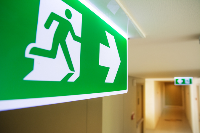 A fire exit safety signage in a new property development that adheres to government safety legislation for residents